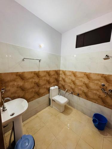 a bathroom with a toilet and a sink at Sanchi's Homestay 2BHK in Bhowāli