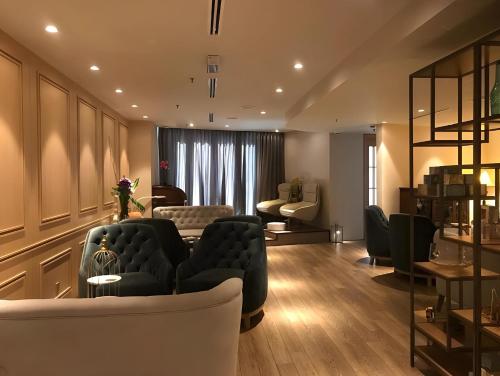 a living room with a couch and a table at Ascott Kuala Lumpur in Kuala Lumpur