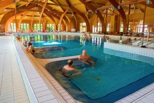 a group of people in a swimming pool at Limonádé Apartman AC Agárd Élményfürdő mellett in Gárdony