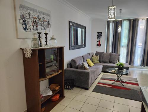 a living room with a couch and a table at Ashkelon a front of the sea in Ashqelon