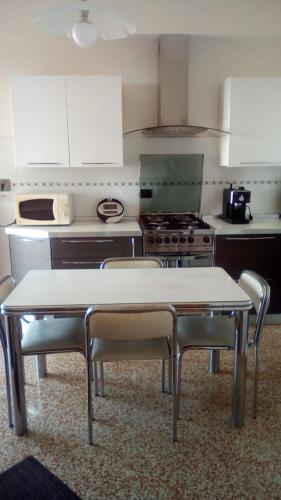 a kitchen with a table and chairs in it at Terrazza sul mare citra 1666 in Genova