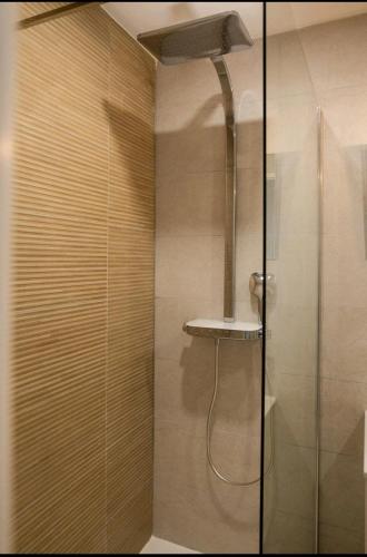 a shower with a glass door in a bathroom at Le Candle - Parking & Balcon - Muret - Toulouse in Muret