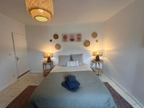 une chambre avec un grand lit avec deux lampes dans l'établissement Large Apartment in City Center, à Honfleur