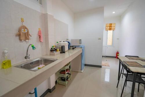 a kitchen with a sink and a counter top at Little Yellow House - AoNang in Ao Nang Beach