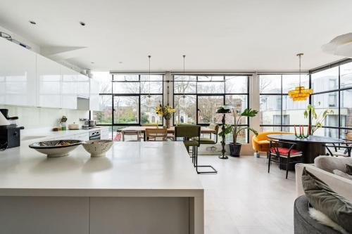 a kitchen and living room with a white counter top at Unique Flat with Pool in Trendy Peckham Area in London
