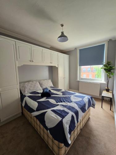a bedroom with a bed with a cat laying on it at Great Flat Close to Edgware Road in London