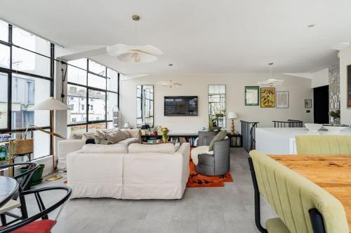 a living room with two white couches and a table at Unique Flat with Pool in Trendy Peckham Area in London