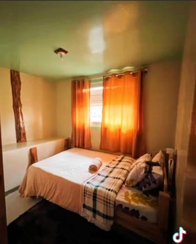 a small bed in a room with a window at Couple's Unit at BOONE'S in Sagada