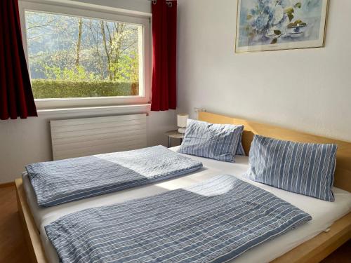 two beds in a room with a window at Stubai Apartment Telfes in Telfes im Stubai