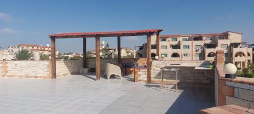 a patio with a gazebo on top of a building at شاليه في قرية هيلو بيتش في الكيلو ٥٠ in Borg El Arab