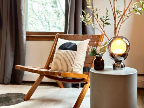 a room with a chair and a table with a lamp at Downtown New Haven by Yale & Little Italy - AO Destinations in New Haven