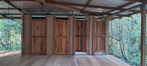 an empty room with wooden doors on a deck at Casa Maya in La Viña