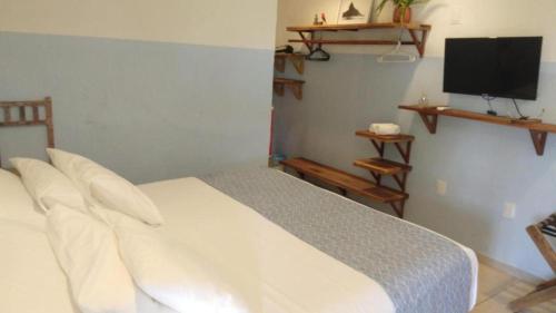 Postel nebo postele na pokoji v ubytování Ecocharme Pousada do Marcilio