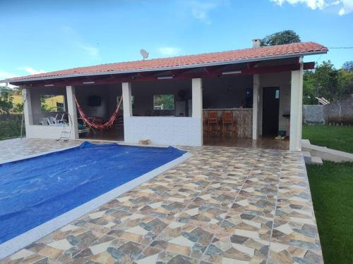 une maison avec une piscine dans la cour dans l'établissement Chácara Charbella, à Três Ranchos