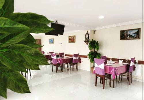 a dining room with purple tables and chairs at Star Hotel in Shamakhi