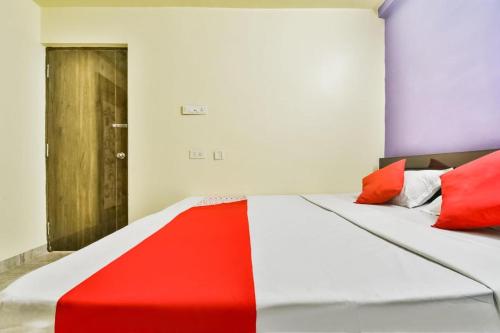 a red and white bed in a room at Hotel Mahal Inn in Patna