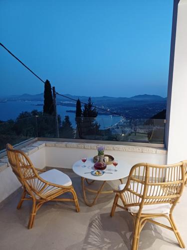 a table and two chairs on a balcony with a view at Villa Filothea with Jacuzzi and sea view in Spartýlas