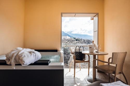 a room with a table and a view of a mountain at Hotel Villa Madruzzo in Trento