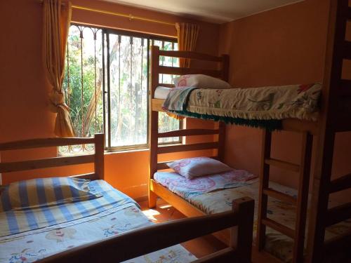 a room with two bunk beds and a window at Finca Agroturística El Portal in Gachetá