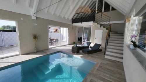 a house with a swimming pool in a living room at Villa Delta Spa in Munchhausen
