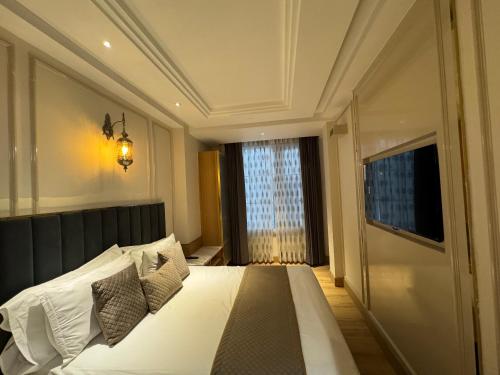 a bedroom with a large bed with a window at EMPIRE PLATINUM SUITES in New Delhi