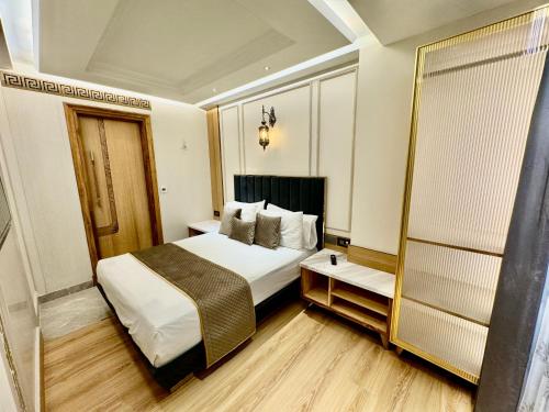 a hotel room with a bed and a mirror at EMPIRE PLATINUM SUITES in New Delhi