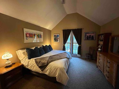 a bedroom with a large bed and a window at Corktown Cottage in Detroit