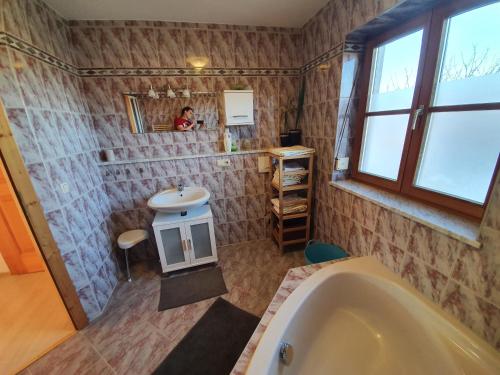 La salle de bains est pourvue d'une baignoire et d'un lavabo. dans l'établissement Erdgeschosswohnung mit Terrasse (Netflix, YouTube premium, ...), à Otting