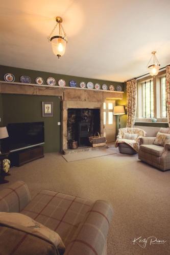a living room with a couch and a fireplace at Rock House BNB in Bakewell