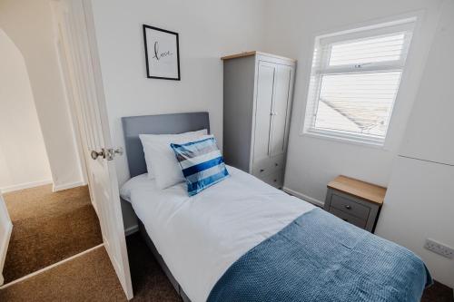 a bedroom with a bed with a pillow on it at The Nest at Blackburn in Cherry Tree