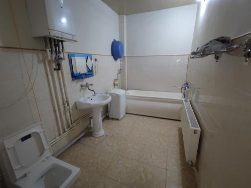 La salle de bains est pourvue de toilettes, d'un lavabo et d'une baignoire. dans l'établissement Sheki city villa, à Shaki