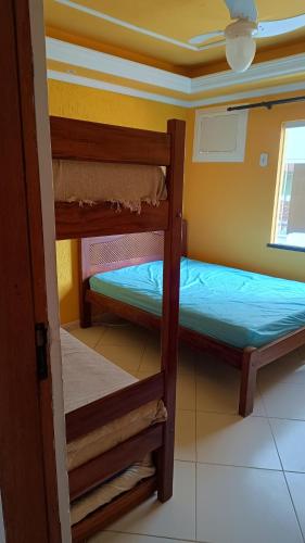 two bunk beds in a room with a ceiling at Hospedagem do Neto in Saquarema