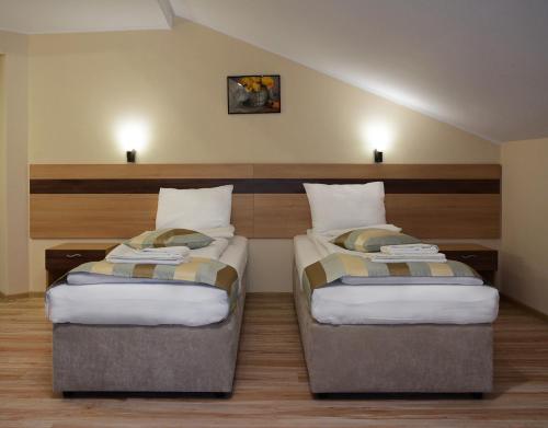 a room with two beds in a room at City House Family Hotel & Restaurant in Ruse