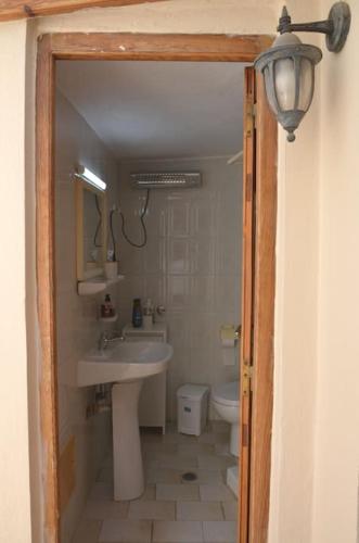 a bathroom with a sink and a toilet at Διαμέρισμα Έλλη in Rethymno