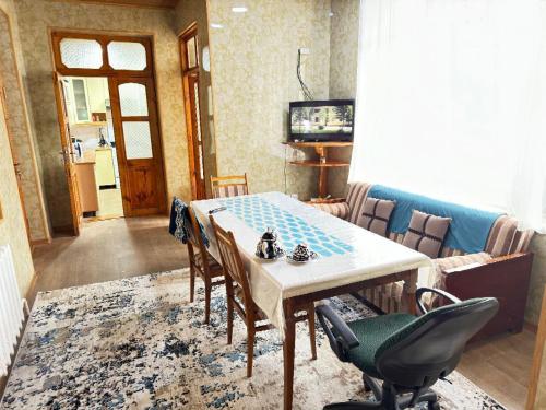 a dining room with a table and chairs at willa hostel in Yunusobod