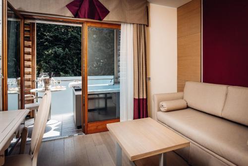 a living room with a couch and a table at Hotel Villa Madruzzo in Trento