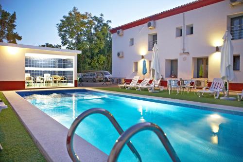 a swimming pool in front of a villa at Solar de Alqueva in Reguengos de Monsaraz