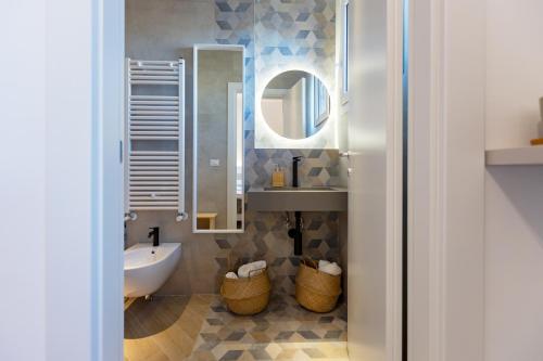 a bathroom with a sink and a mirror at PDS ROOMS in Brindisi