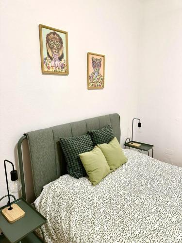 a bedroom with a bed and two pictures on the wall at Casa Ganza in Pisa