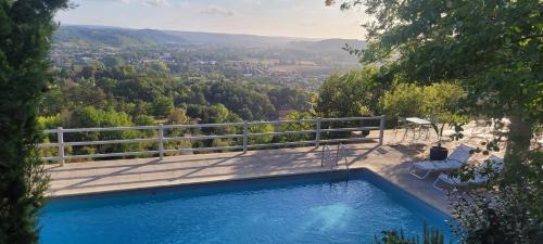 a swimming pool with a view of a valley at Le Clos Des Etoiles in Le Bugue