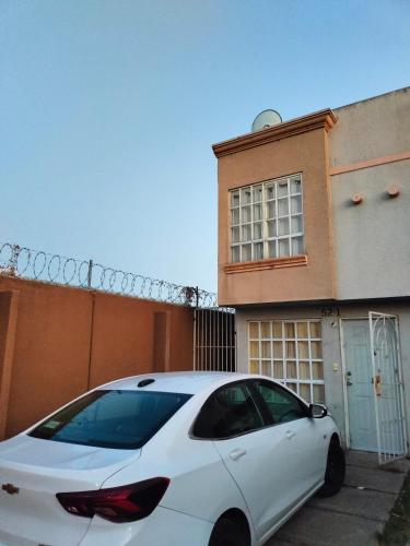 a white car parked in front of a building at Casita bonita in San Gregorio Cuautzingo