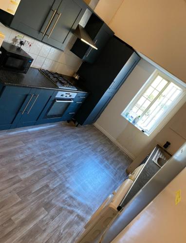 an overhead view of a kitchen with blue cabinets at Room in CV1 Fargo Village Room with private bathroom in Parkside