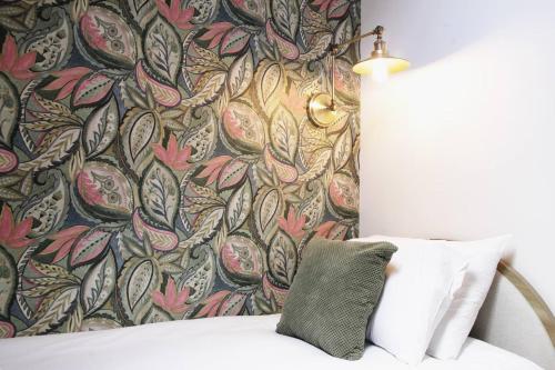 a bedroom with a bed with a floral wallpaper at Pass the Keys Apartment 3 Old Conservative Club in Historic Town in Caernarfon
