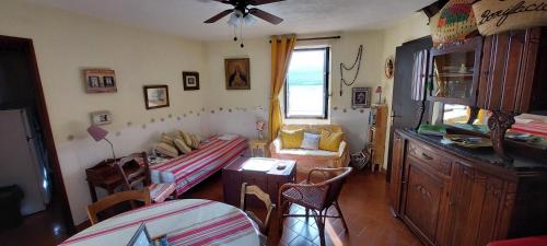 un salon avec un canapé et une table dans l'établissement Maison de village sur la citadelle de Calvi, à Calvi