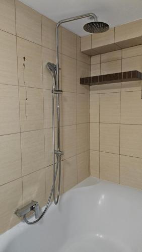a shower in a bathroom with a tub at Pięćdziesiątka in Płock