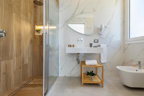 a bathroom with a sink and a shower at Case Vacanza Loria in Castelluzzo