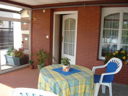 a table with a blue and yellow table cloth on a patio at Apartments - Penzion Lena in Hradec Králové