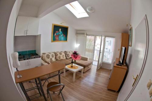 a living room with a couch and a table at Apartments Bonus in Budva