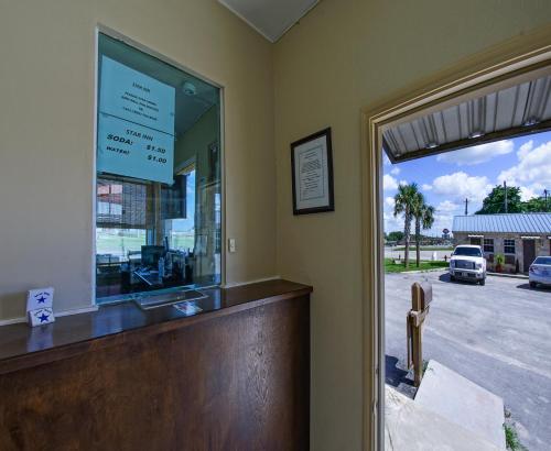 a bar with a window and a view of a street at Star Inn in Karnes City