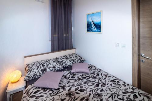 a bedroom with a bed with two pillows on it at Moon Apartment in Split